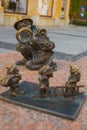 WROCLAW, POLAND: Girl photographer through a magnifying glass looks at the dwarves who are carrying a ladder