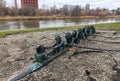 Wroclaw, Poland - January 06 2020: Sculpture of miniature dwarfes team sailing in a long boat against riverside. Dwarfes -