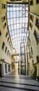 Large vertical panorama of interior of renovated passage under the blue sun