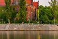 Beautiful and colorful facade of National Museum full of ivy next to promenade over the Odra river