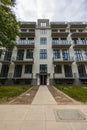 Facade of modern block of flat full of modern apartments at new estate at sunny and cloudy