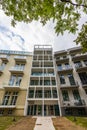 Facade of modern block of flat full of modern apartments at new estate at sunny and cloudy