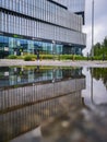 Facade of Silver Tower Center building reflected in puddle Royalty Free Stock Photo
