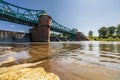 Long Bartoszowicki bridge full of walking tourists and cyclists over water level seen from dried