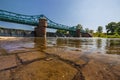 Long Bartoszowicki bridge full of walking tourists and cyclists over water level seen from dried