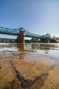 Long Bartoszowicki bridge full of walking tourists and cyclists over water level seen from dried