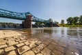 Long Bartoszowicki bridge full of walking tourists and cyclists over water level seen from dried