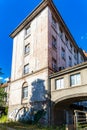 Outdoor facade of ruins of old hospital during urban exploration at sunny day