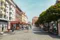 Wroclaw, Poland - June 2023: Street with cobblestone road with green trees, colorful buildings, summer cafe, Cathedral Royalty Free Stock Photo