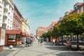 Wroclaw, Poland - June 2023: Street with cobblestone road with green trees, colorful buildings, summer cafe, Cathedral Royalty Free Stock Photo