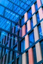 Upward view of a tall and modern office building full of glass windows reflecting the walls, Royalty Free Stock Photo