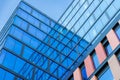 Upward view of a tall and modern office building full of glass windows reflecting the walls, Royalty Free Stock Photo