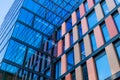 Upward view of a tall and modern office building full of glass windows reflecting the walls, Royalty Free Stock Photo