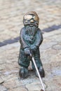 Wroclaw dwarf, small fairy-tale bronze figurine on the side walk, Wroclaw, Poland