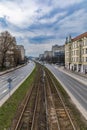 Long and wide Legnicka street with road and tram rails at cloudy sunny day seen from footbridge