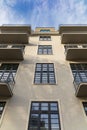 Lookup to facade of modern apartment building with big windows and balconies Royalty Free Stock Photo