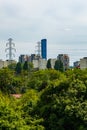 Beautiful cityscape at cloudy day with energy towers and a lot of energy lines with small trees and Royalty Free Stock Photo