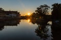 Beautiful sunset over Odra river and trees with sun reflecting in water Royalty Free Stock Photo