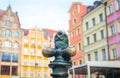 Wroclaw, Poland, May 7, 2019: Dwarf is sitting on street water tap on Rynek Market Square Royalty Free Stock Photo