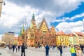 Wroclaw, Poland, May 7, 2019: Old Town Hall building with clock tower spire and crowd of many people Royalty Free Stock Photo