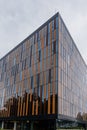 Upward view to modern corporate building with windows and bronze panels Royalty Free Stock Photo