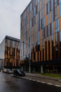 Upward view to modern corporate building with windows and bronze panels Royalty Free Stock Photo