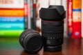 Zoom lens for Canon cameras RF 24-105mm f4 standing next to lying RF 35mm f 1.8 macro lens on