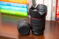 Zoom lens for Canon cameras RF 24-105mm f4 standing next to lying RF 35mm f 1.8 macro lens on