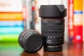Zoom lens for Canon cameras RF 24-105mm f4 standing next to lying RF 35mm f 1.8 macro lens on