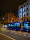 High speed riding tram through the street at night