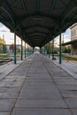 Symmetrical view of long platform of old Wroclaw Swiebodzki railway station with green roof and