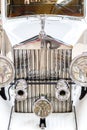 Frontlights and radiator of old Exclusive Luxury Rolls-Royce vintage car ckose-up. Royalty Free Stock Photo
