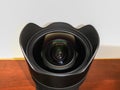 Big black wide angle zoom camera lens Sigma Art 14-24mm DG HSM with built in lens hood and Royalty Free Stock Photo