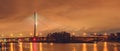 Wroclaw, Redzinski bridge over Odra river, illuminated structure at night with low hanging clouds over the city. Royalty Free Stock Photo