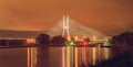 Wroclaw, Redzinski bridge over Odra river, illuminated structure at night with low hanging clouds over the city. Royalty Free Stock Photo