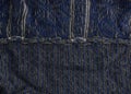 Wrong side of gray knitted fabric with a blue pattern