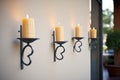 wrought iron candle sconces on textured stucco walls