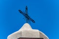 Wrought iron cross on blue sky - Christian religious symbol Royalty Free Stock Photo