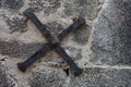 wrought iron cross bracing supporting the stone facade of an old medieval house