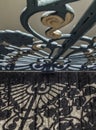 Wrought iron decorative fence on bridge and shadow