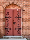 Wrought iron door fittings on a brick wall