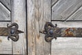 Wrought iron door hinge on old wooden background Royalty Free Stock Photo