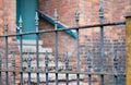 Wrought Iron Fence with Brick Wall Background. Royalty Free Stock Photo