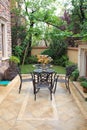 Wrought iron furniture in airy courtyard Royalty Free Stock Photo