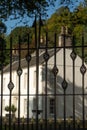 Wrought Iron Gate With An Elegant Mansion House in the Background Royalty Free Stock Photo