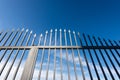 Wrought Iron Gate with Sharp Points on Blue Sky with Clouds Royalty Free Stock Photo