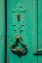 Wrought iron keyhole and handle in an old wooden door Royalty Free Stock Photo