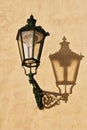 Wrought-iron lantern with its shadow on the yellow wall, Prague, Royalty Free Stock Photo