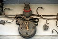 A wrought-iron owl sitting on a clock on the facade of a building