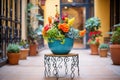 wrought iron plant stand with colorful flowers in a bright courtyard Royalty Free Stock Photo